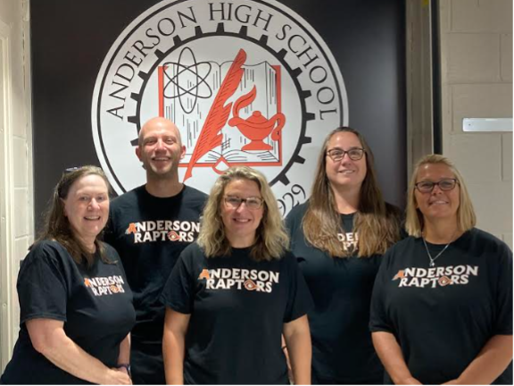 The Anderson counseling staff in front of the school seal